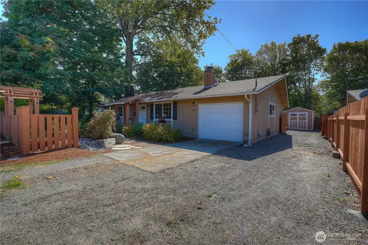 Attached garage, driveway, and RV parking along the side of the home.