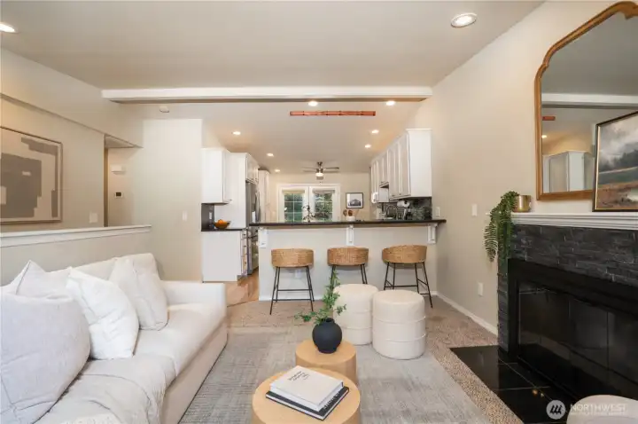 Enter into an open concept living space with tall ceilings, and recessed lighting.