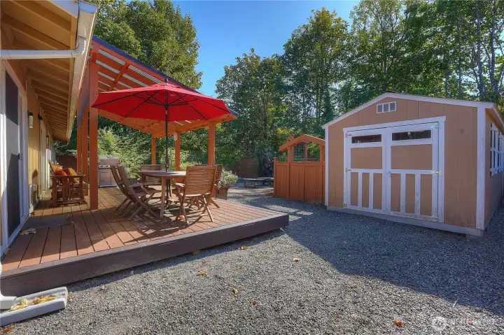 Large storage shed with fence along the side to leave project materials out of sight.