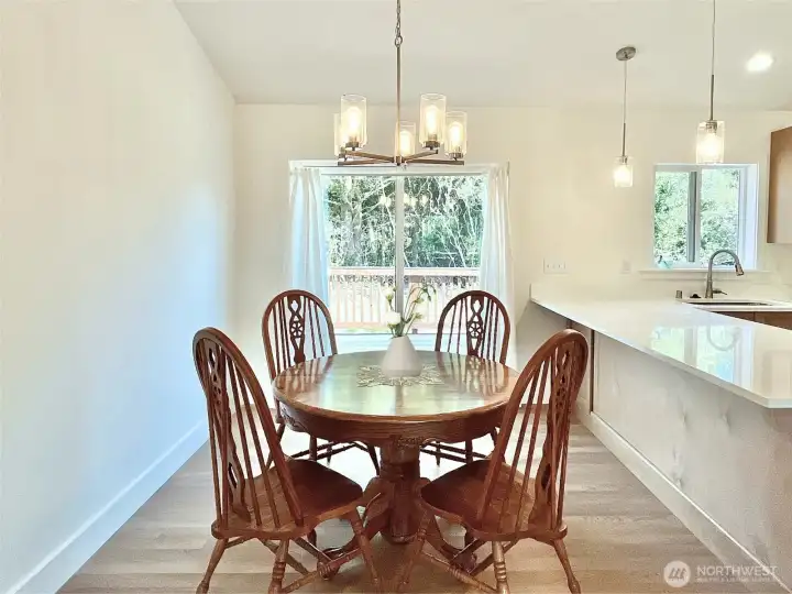 Large Dining Space with Slider Door leading to the Outdoor Deck. Virtually Staged