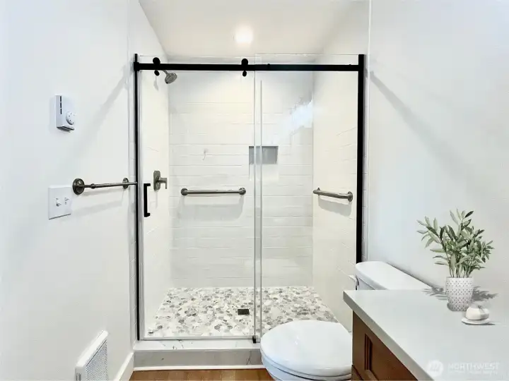 Just off the Primary Bedroom is this bright En-Suite with a Walk-In Shower with Glass Door. Virtually Staged.