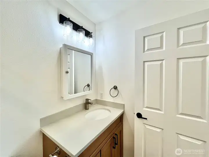 Primary Bathroom also has a beautiful vanity and bright lighting