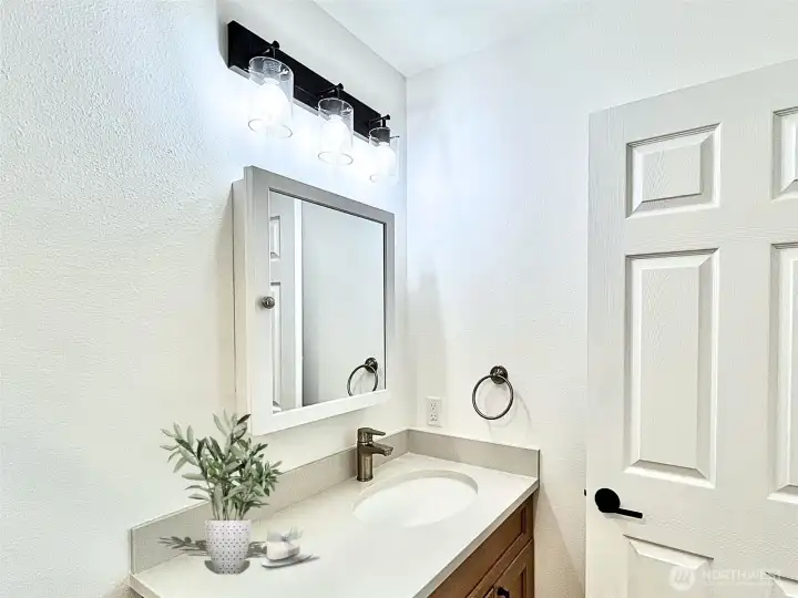 Modern Lighting, Durable Flooring and Convenient Access for the En-suite Bathroom. Virtually Staged.