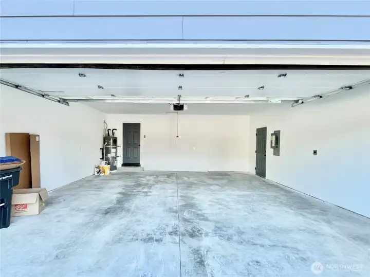 Large Two Car Garage with Side Door. Electric Vehicle EV Charger located by Panel. Large Two Car Garage with Side Door. Electric Vehicle EV Charger located by Panel.