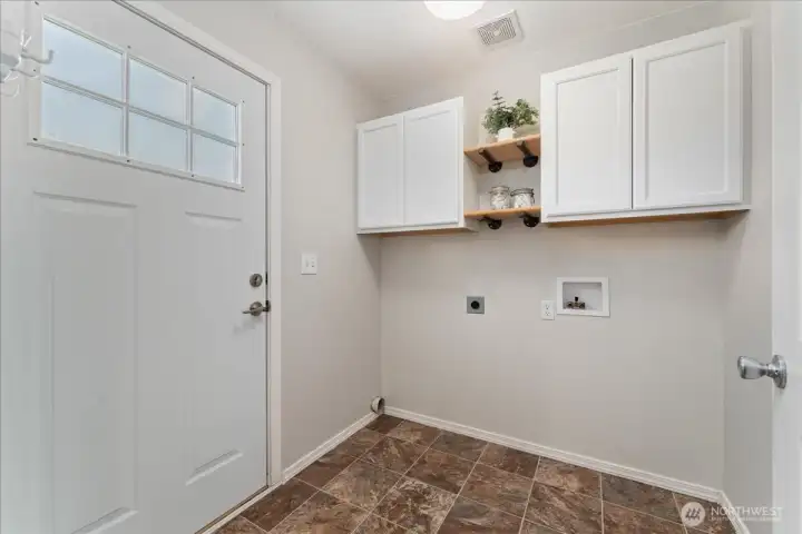 Laundry off of kitchen with door to backyard
