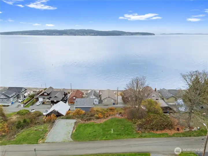 A blank canvas with spectacular water and mountain vistas in every direction.Upper Lot,  grassy area has neighbors drain field on it.