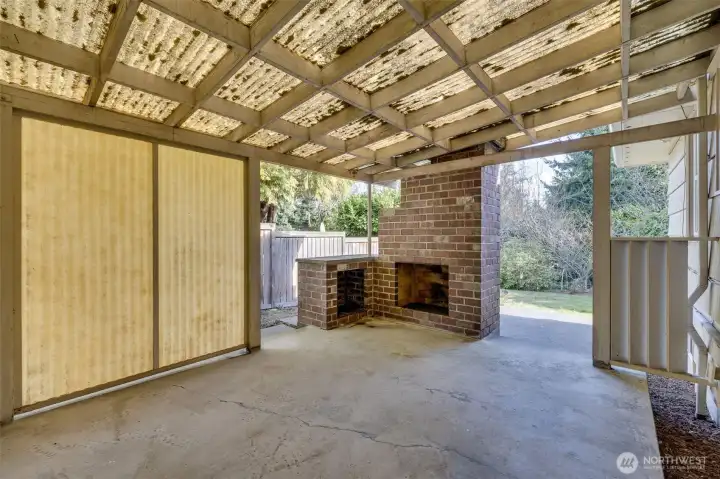 Covered back patio with wood burning fireplace