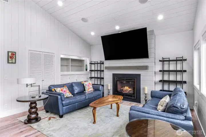 Cozy living room space with fireplace, built in storage and book shelves