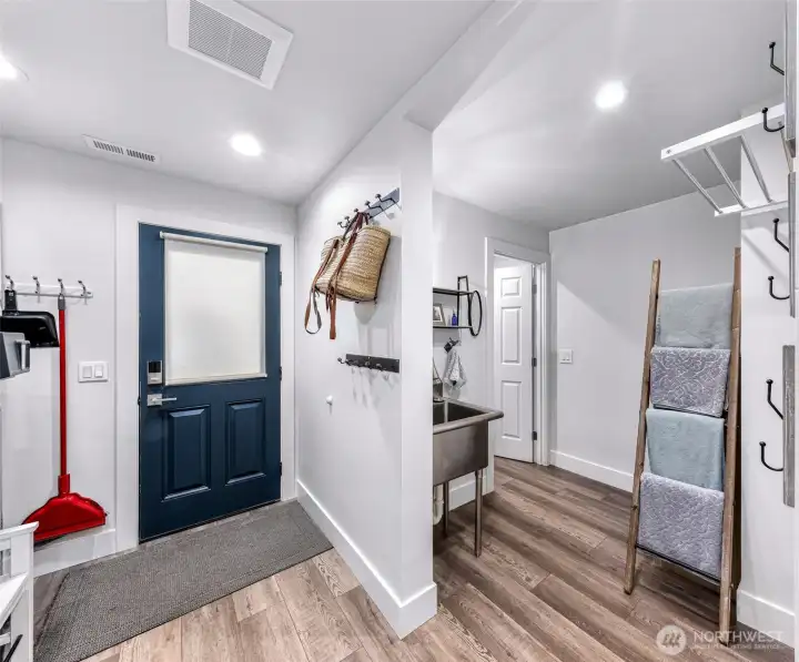 Lower level utility room with access to back patio, connected 1/2 bath and additional storage space.