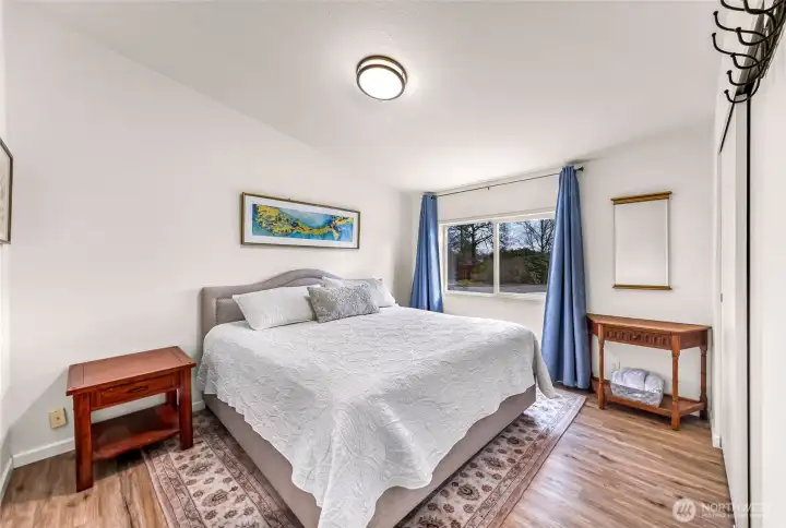 Primary bedroom, located off the kitchen area with connected bath