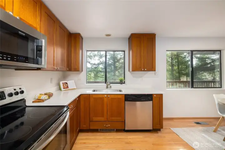 Kitchen windows look out to the trees.