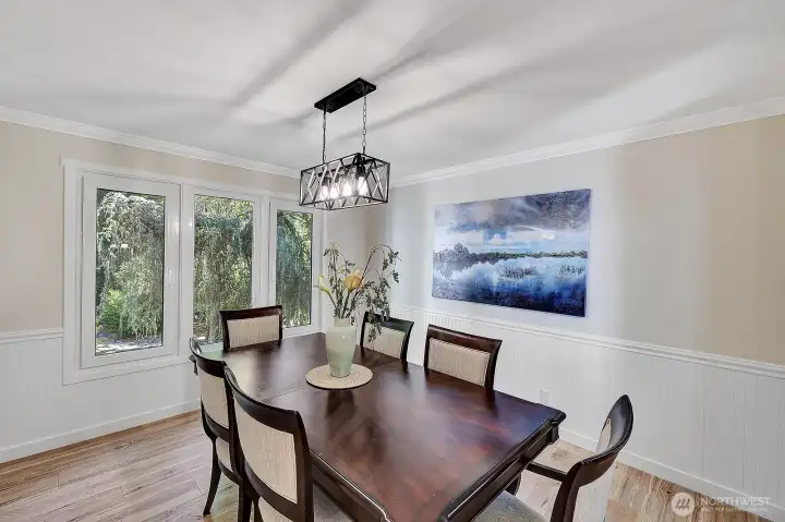 Formal dining room has practical wainscotting on walls