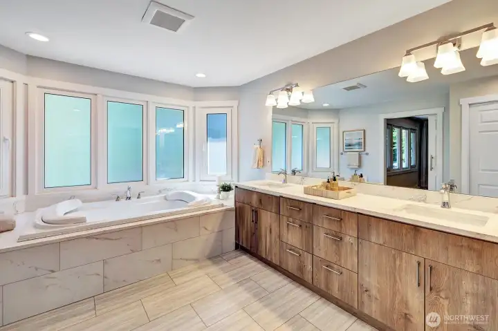 5-piece primary bathroom has LED lighting around tub.