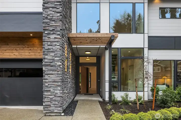 A custom pivot door welcomes you into a residence that immediately impresses.