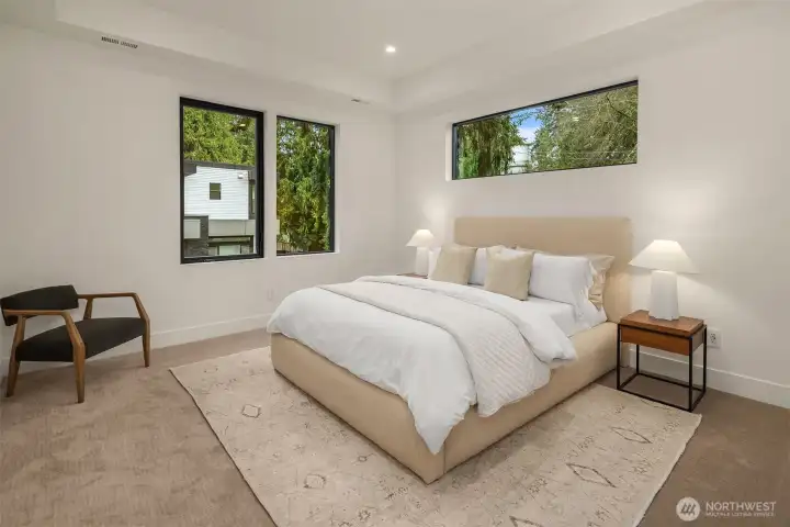 One of three ensuite bedrooms complete with high-end custom cabinetry in the closets.