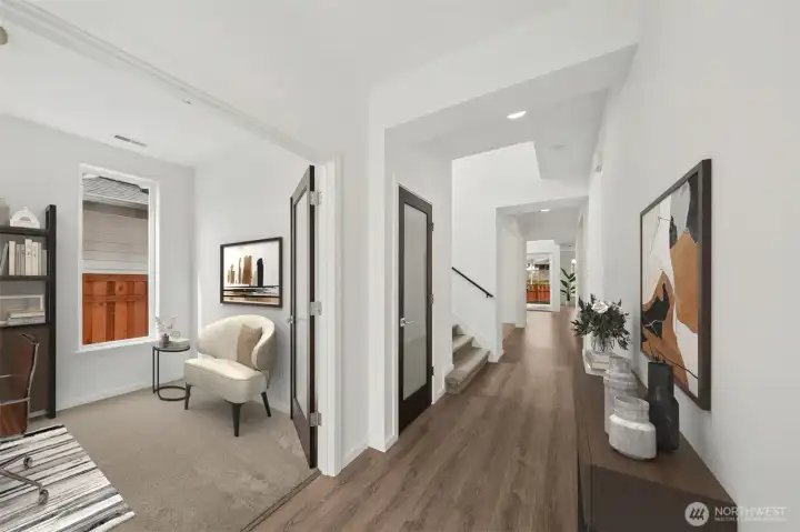 View as you walk in. Office with french doors to immediate left, open den/ office/ flex just passed the stairs on the left.