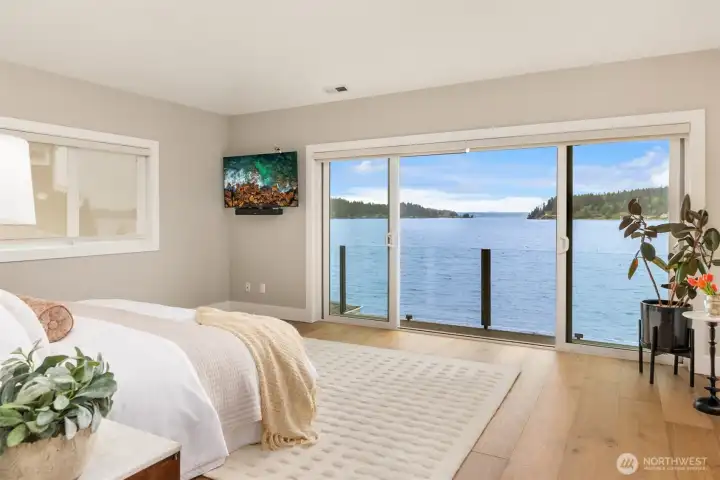 This is the luxurious primary! You're never going to want to ge tout of bed!! Sliders that open for the salt air breeze...