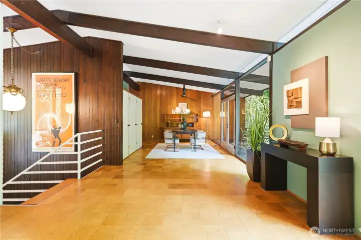 Looking past the staircase toward the dining area and the kitchen beyond.