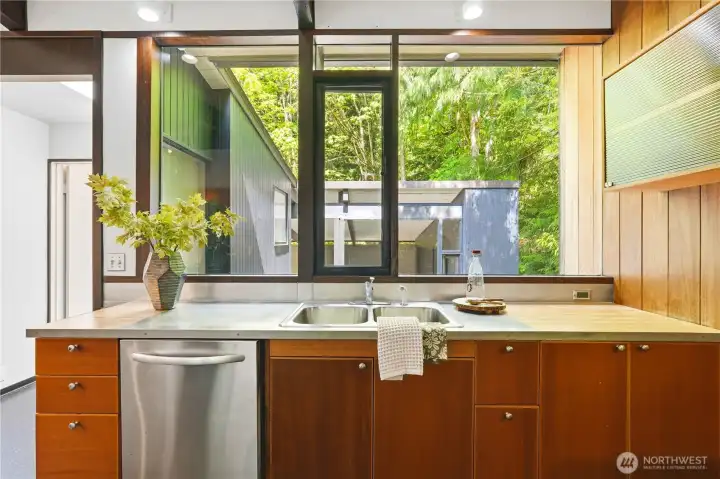 A generous bank of windows above the sink floods the kitchen with natural light.