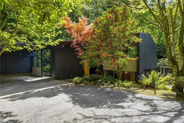 Mature landscaping provides a natural screen from the street, giving the home a strong sense of privacy.