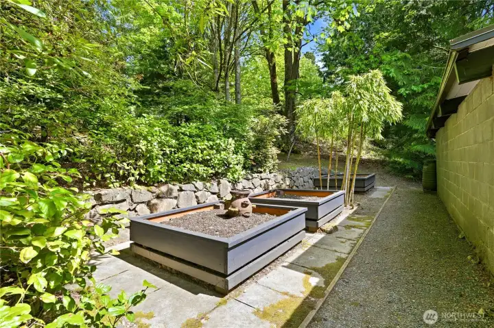 Raised garden beds are alongside the carport, ready for the home gardener.