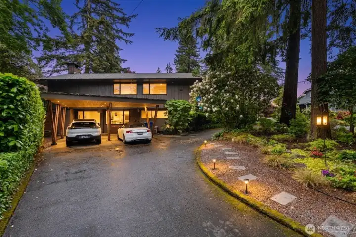 Striking Northwest contemporary architecture surrounded by mature landscaping and towering evergreens. Striking Northwest contemporary architecture surrounded by mature landscaping and towering evergreens.