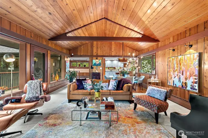Vaulted wood-paneled great room showcasing dramatic architectural lines and warm natural textures. Vaulted wood-paneled great room showcasing dramatic architectural lines and warm natural textures.