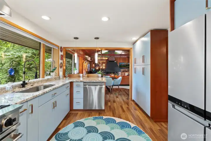 Spacious entertainer’s kitchen with generous prep space, sleek pendant lighting, and timeless mid-century influence. Spacious entertainer’s kitchen with generous prep space, sleek pendant lighting, and timeless mid-century influence.
