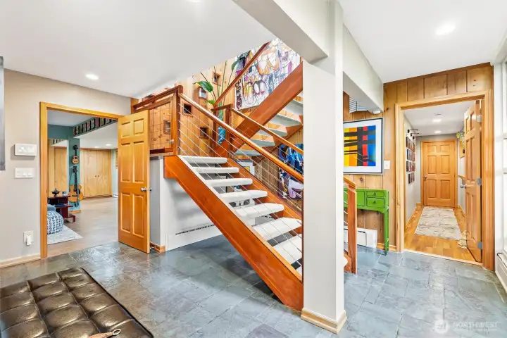 Lower level staircase that leads from the front door to the main floor. Lower level staircase that leads from the front door to the main floor.