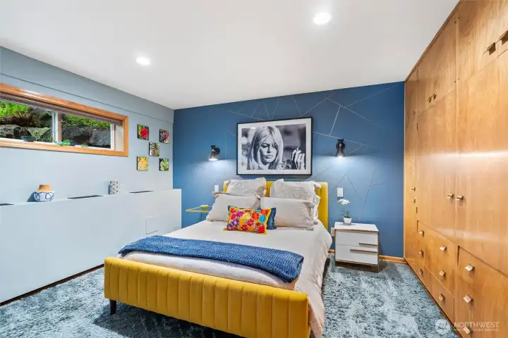 Lower level bedroom with built-ins, bold designer accents, and serene ambiance. Lower level bedroom with built-ins, bold designer accents, and serene ambiance.