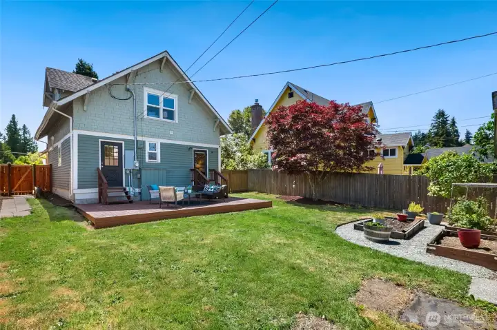 Gorgeous backyard with freshly painted deck for basking in the summer sun.