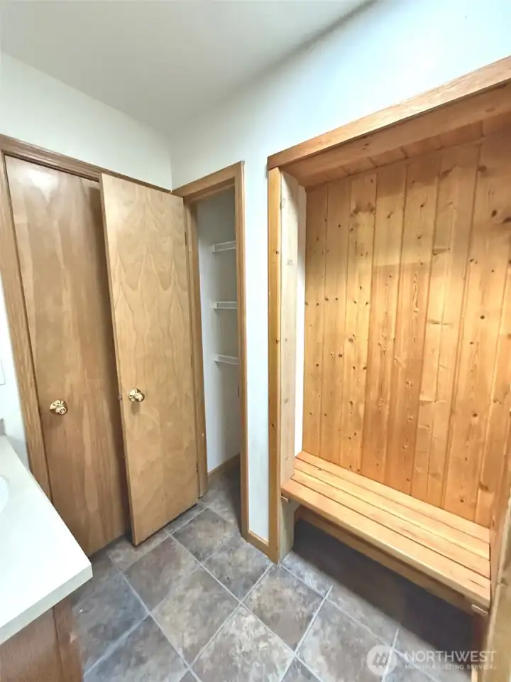 Guest bathroom has a beautiful bench & area to hang your cloths!