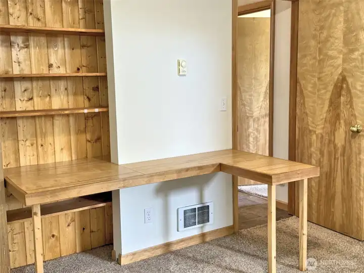 Office area with shelving a closet.