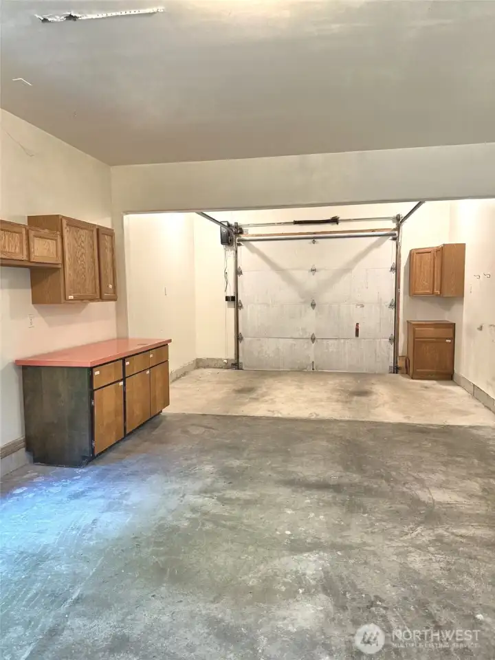 Attached garage with shelving.