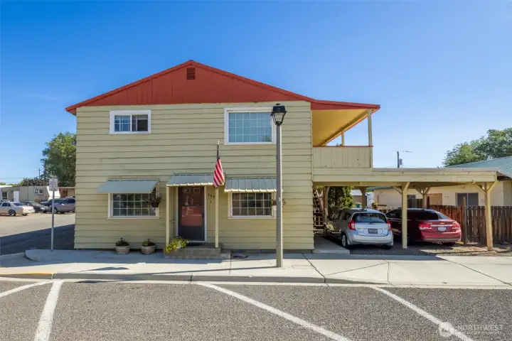 Front building with 2 spots of covered off street parking.