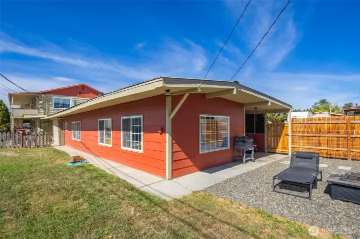 Separate single family home with its own fenced yard.