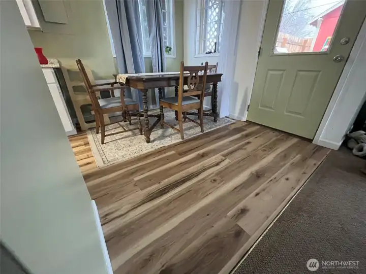 Cozy dining area adjoining the kitchen. Back home has new vinyl plank flooring.