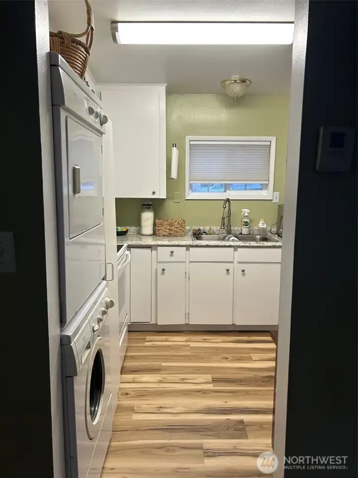 Kitchen also features a stack washer and dryer.