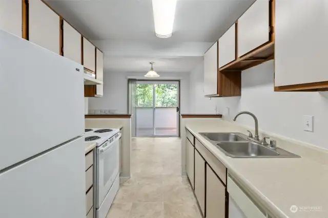 Galley kitchen with tons of storage space. This open-ended design keeps traffic moving and the cook happy! Clean and well kept. Upgrade for value add?