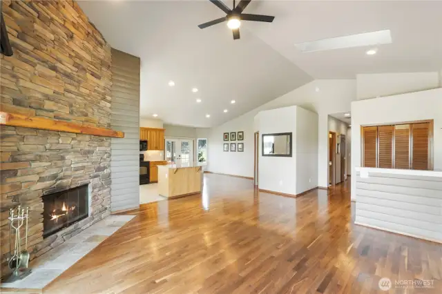 Beautiful hardwood floors flow gracefully throughout the home, adding warmth and continuity.The great room, with its soaring ceilings and striking stone fireplace, offers effortless connectivity to the kitchen and dining area—creating a spacious, open-concept layout that’s perfect for both everyday living and entertaining.