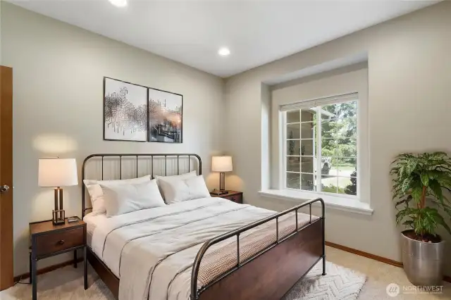 Wander down the hall to find first of two spacious guest bedrooms offered.