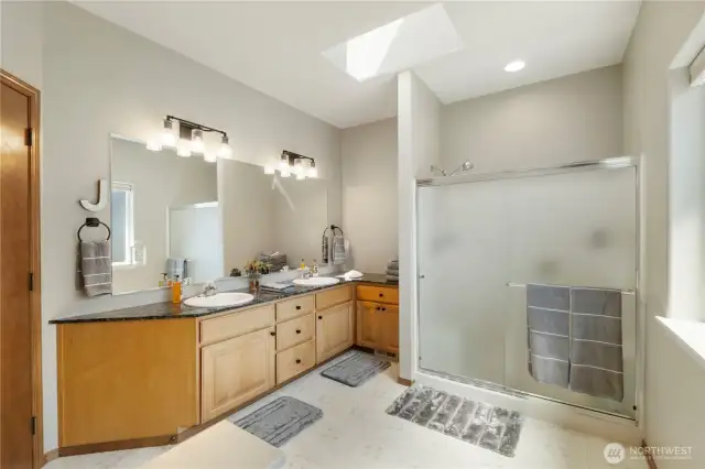 The Primary suite offers this private bath complete with walk-in shower and dual vanities.