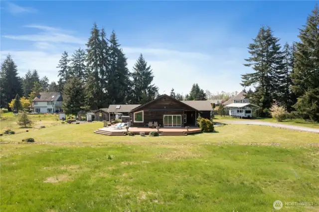 See the magnitude of the size of the deck wrapping over half of the home. RV Parking w/hook up off to the right.
