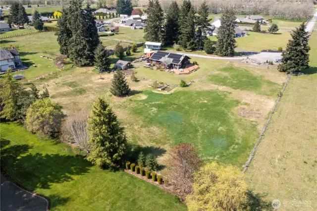 The home is nestled on just under 3 acres. As you come down the driveway note that the solar panels are on the South side of the home and not visible from the front of the house, gaining maximum southern exposure. So many opportunities!