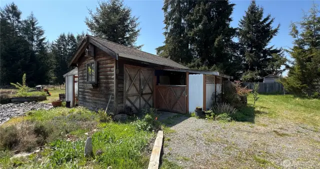 Cute garden shed is perfect for storing tools and completing DIY projects.