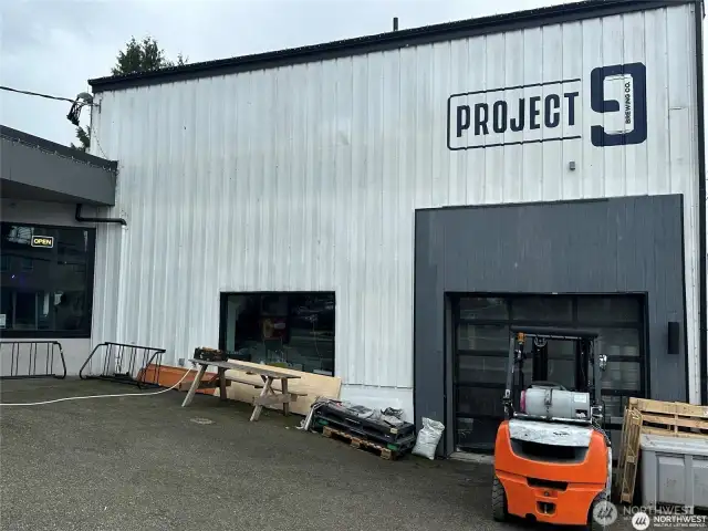 Dangerously close, Project 9 is a true neighbor, three doors away across the alley. New fun brew pub with sunny patio, food trucks, and a great vibe.