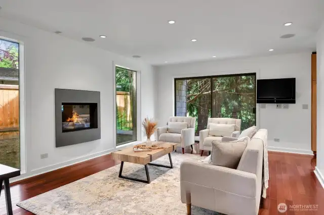 Family room with gas fireplace and Brazilian cherry hardwood floors opens to a covered deck.
