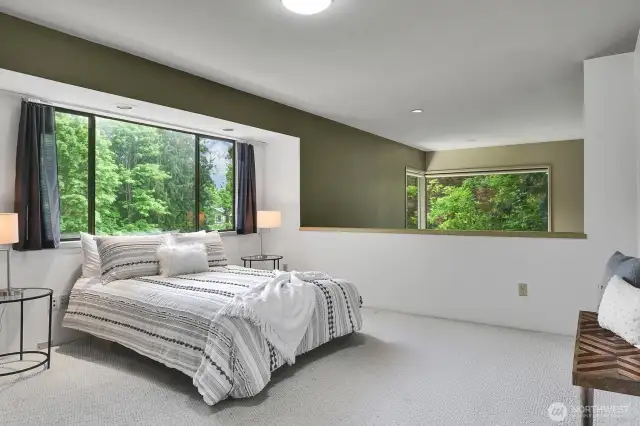 The lofted bedroom in the upper level can serve as a great home office as it enjoys beautiful views of Allen Creek.