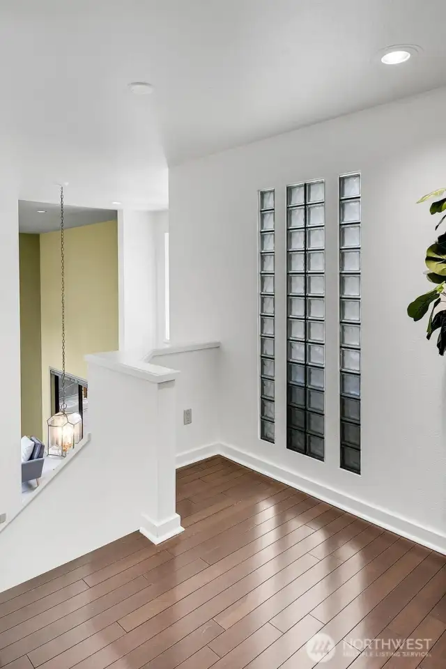 The landing on the upper level features Brazilian cherry hardwood floors and overlooks the entry of the home.