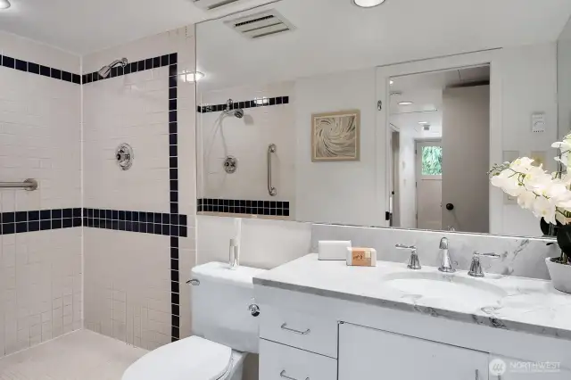 Lower level 3/4 bathroom features a dual headed shower stall.